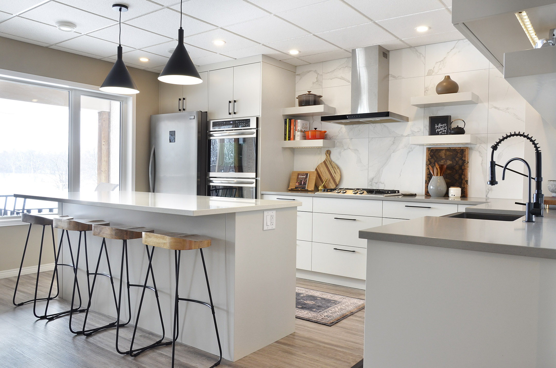 Rivers Edge kitchen renovation Winnipeg island marble modern industrial finishes black faucet