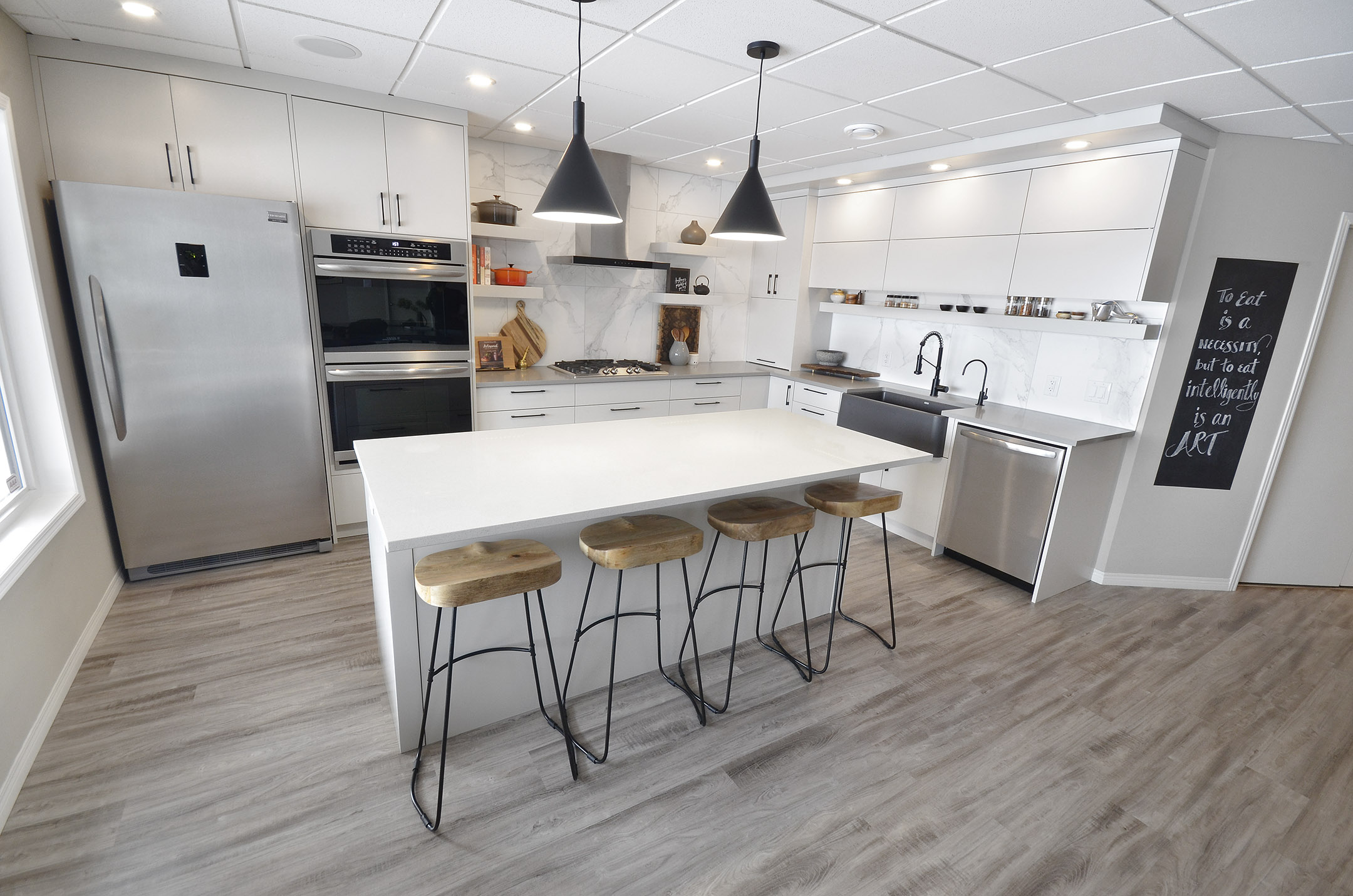 Rivers Edge kitchen renovation Winnipeg island marble modern industrial finishes black faucet grey wood floor