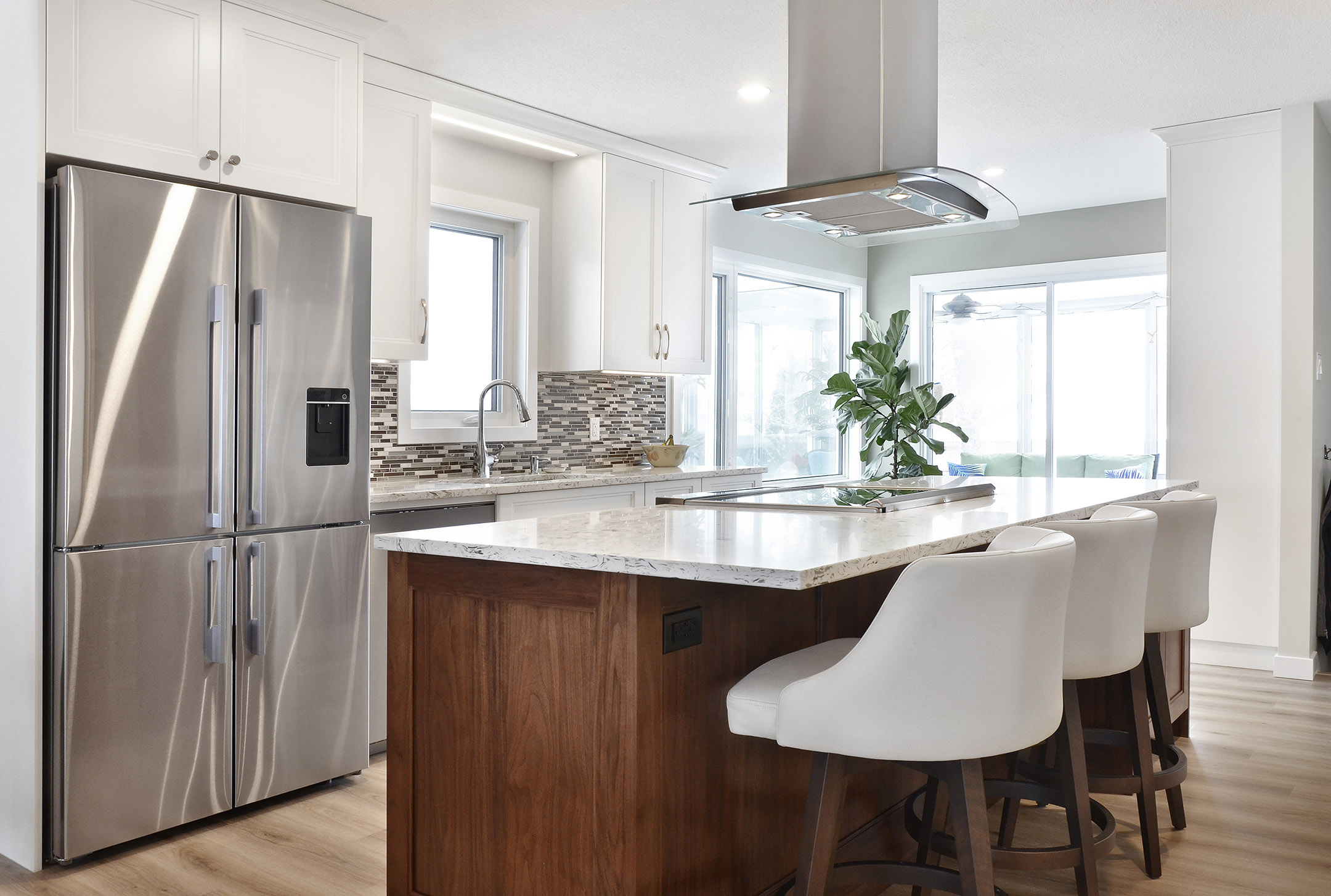 Winnipeg renovations modern kitchen sleek white cabinets white marble countertop double fridge