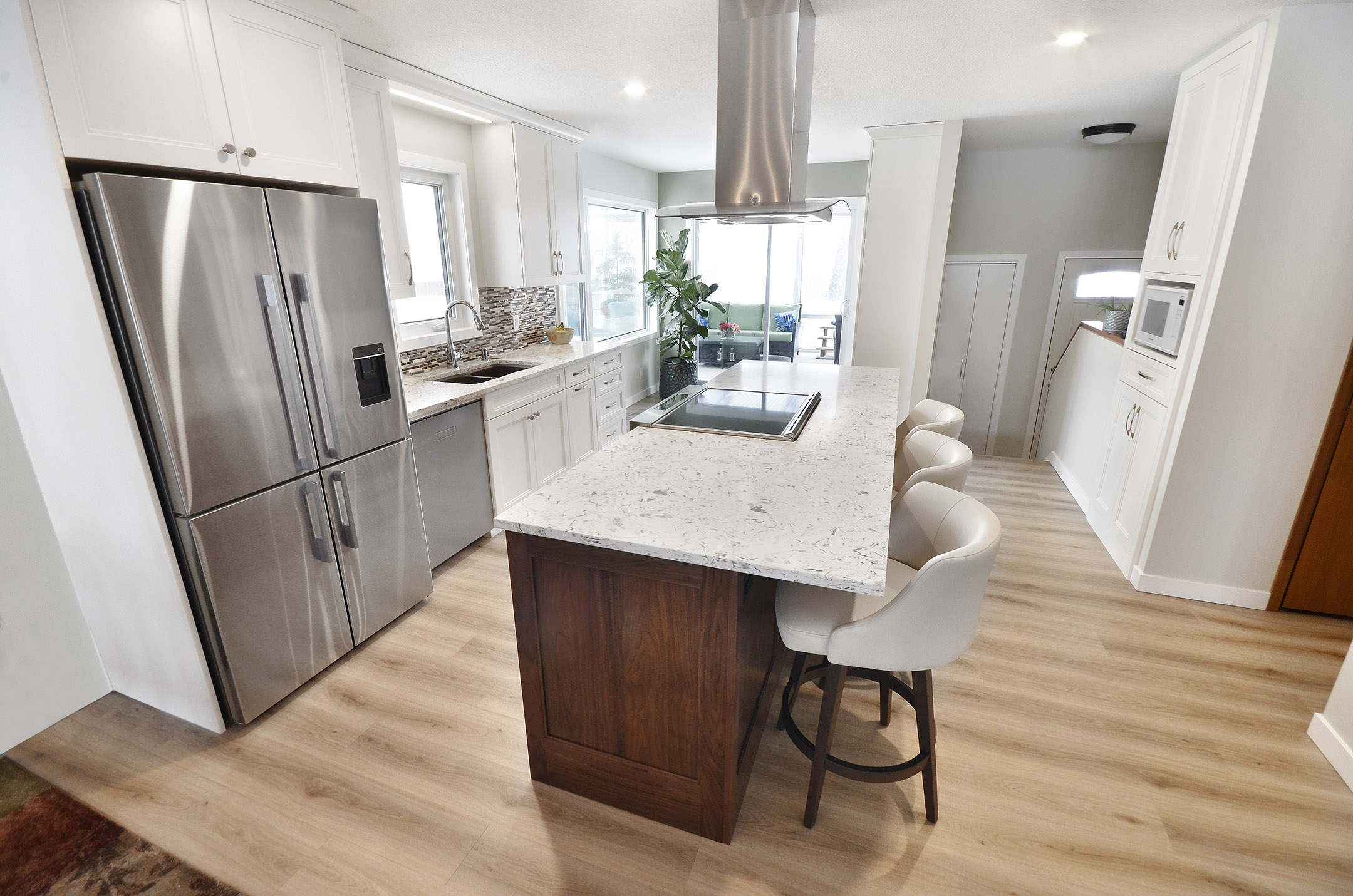 Winnipeg renovations modern kitchen sleek white cabinets white marble countertop breakfast nook island
