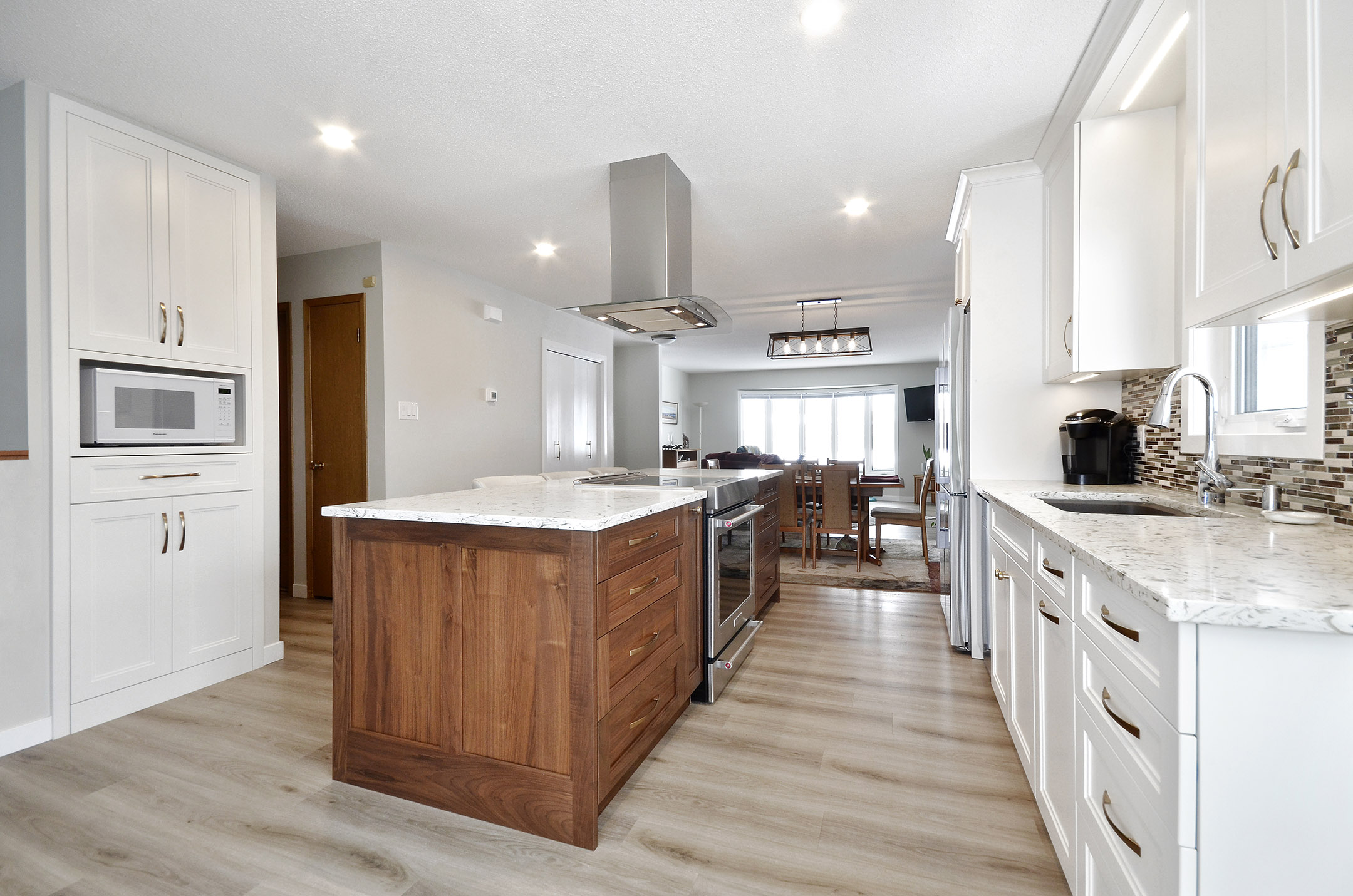 Winnipeg renovations modern kitchen sleek white cabinets white marble countertop modern handles