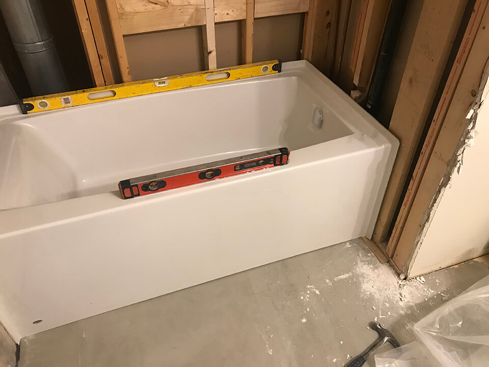 levelling a new tub Bathroom Renovation - Winnipeg Bathroom Renovations - All Canadian Renovations Ltd.